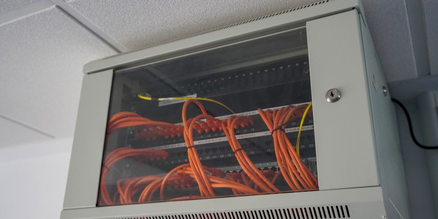 Network switch enclosure high up on a ceiling in a office